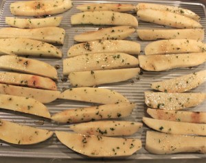 Sliced potatoes on cookie sheet