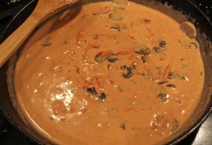 Add tomatoes and heavy cream to create the Pink Vermouth Sauce.